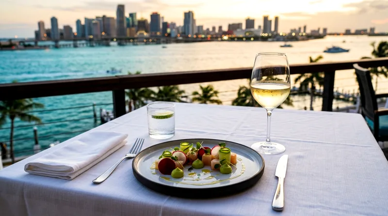 Plated fine dining course with wine glass on white tablecloth overlooking Biscayne Bay.