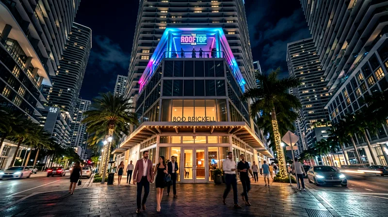 Brickell street entrance to an upscale rooftop bar with pedestrians and neon signage.